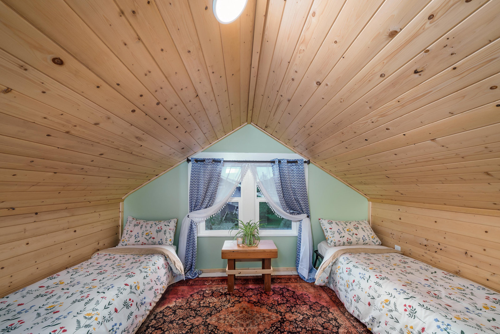 Thoughtfully finished attic with custom wood ceilings